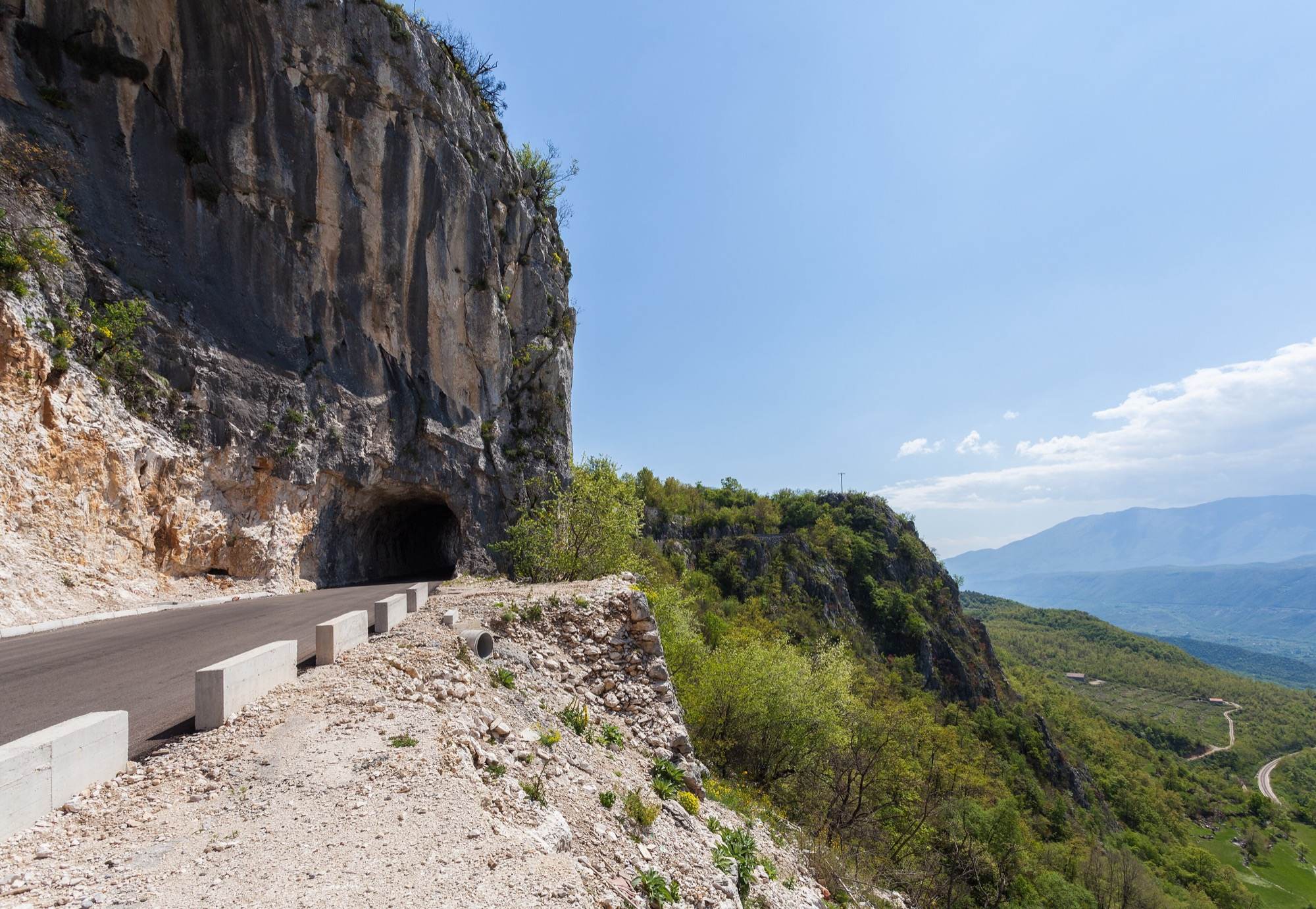 The mountain road to Ostrog Monastery passing through a short rock tunnel