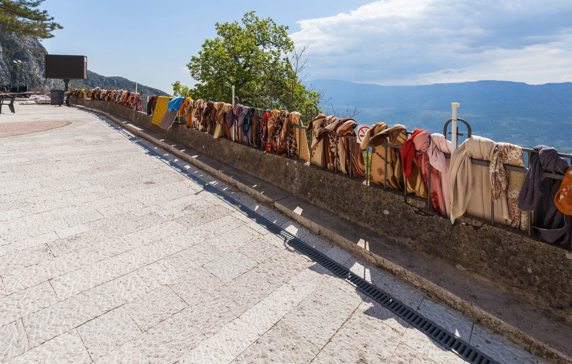 Wraps and scarves for visitors hung along the terrace railing at the Upper Monastery